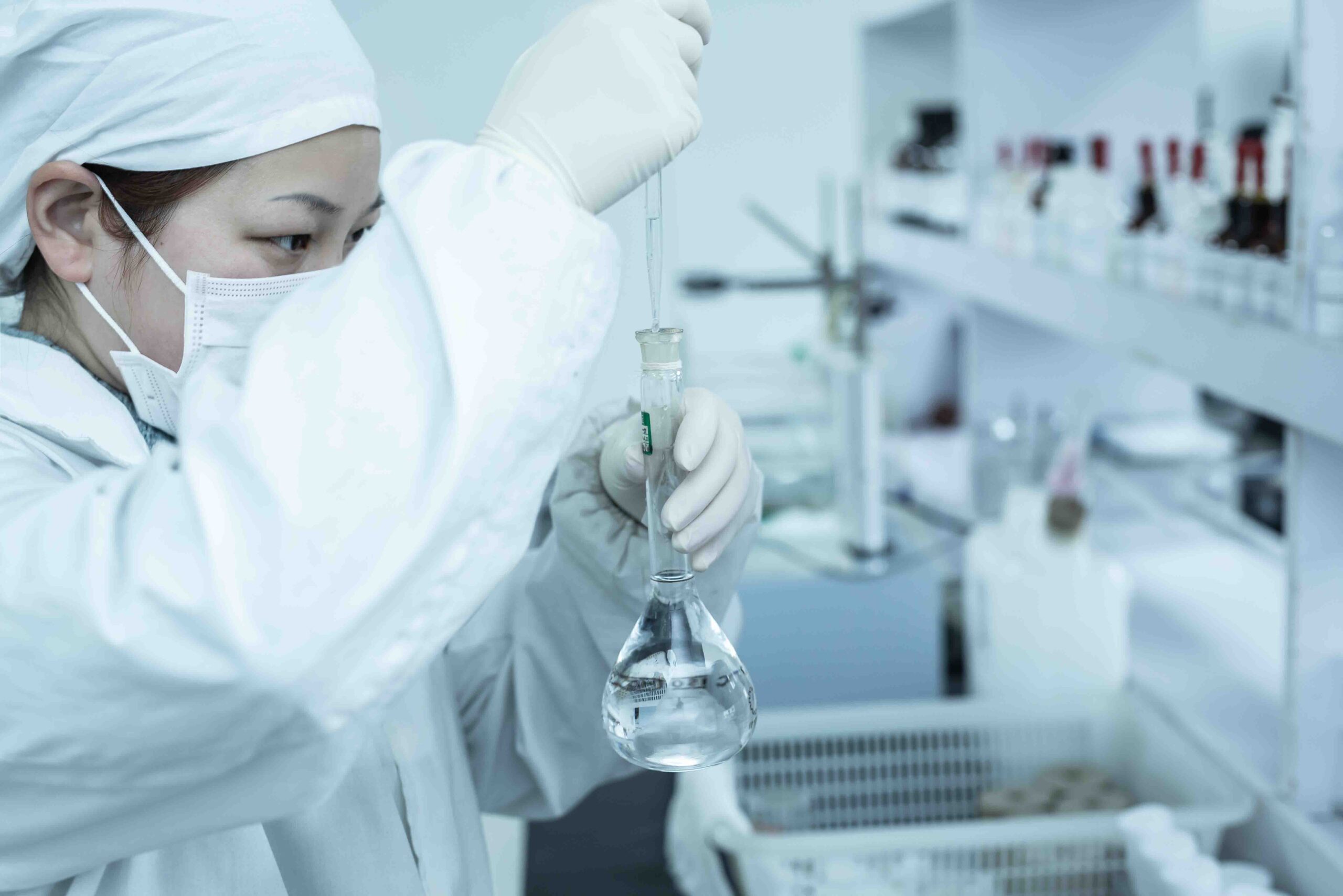 A quality control inspector examining empty vegetable capsules in a manufacturing facility